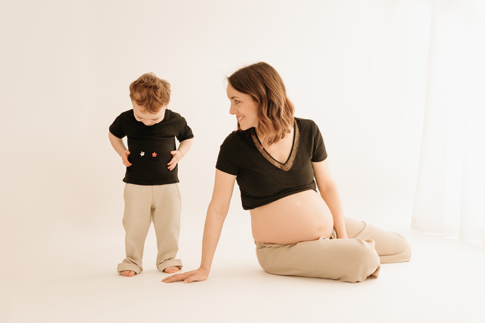 future maman partageant un moment de jeu avec son grand garçon pendant une séance photo grossesse à Tours